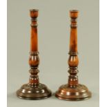 A pair of turned and stained fruitwood candlesticks, 20th century,