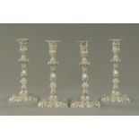 A set of four Edwardian silver candlesticks, Messrs.