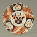 A 19th century Imari plate, with scalloped edge. Diameter 37 cm.