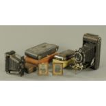 Four vintage folding cameras, and two daguerreotype type photographs.