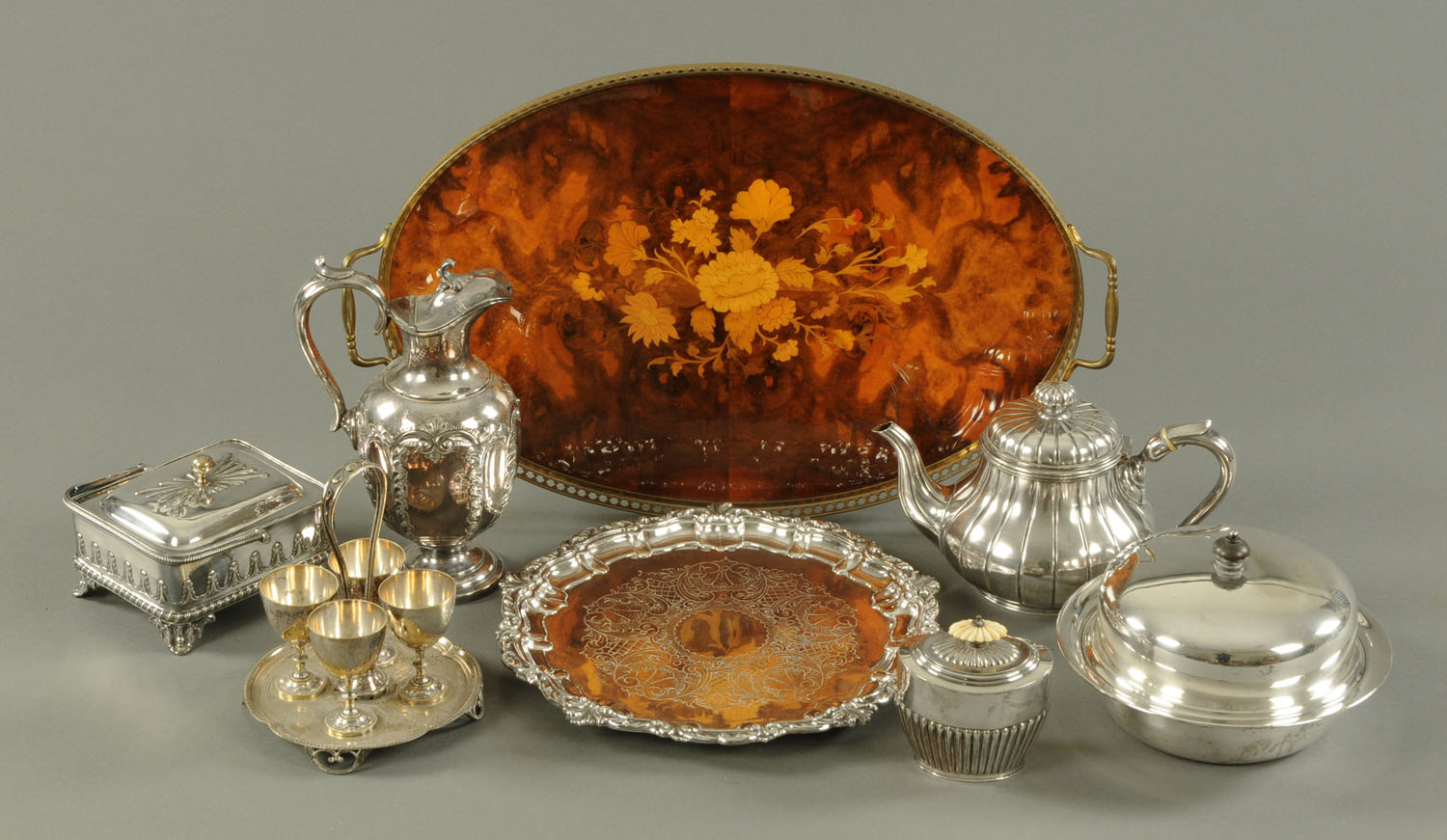 An assortment of silver plate, comprising oval shaped tea caddy, Elkington's melon form teapot,