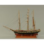 A scratch built model of a three masted clipper, late 19th/early 20th century, on mahogany plinth.