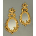 A pair of gilt painted composition Girandole wall mirrors, in the Rococo style.