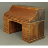 A large late Victorian roll top "city desk", panelled all round and with well fitted interior.