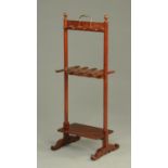 A 19th century mahogany boot and hat rack, with low shelf and scroll feet.