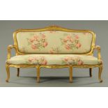 An early 20th century gilt framed settee, with moulded showframe,