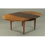 An Edwardian mahogany extending dining table, circular when closed.