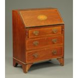 An Edwardian inlaid mahogany bureau, with shell to flap and raised on bracket feet. Width 76 cm.