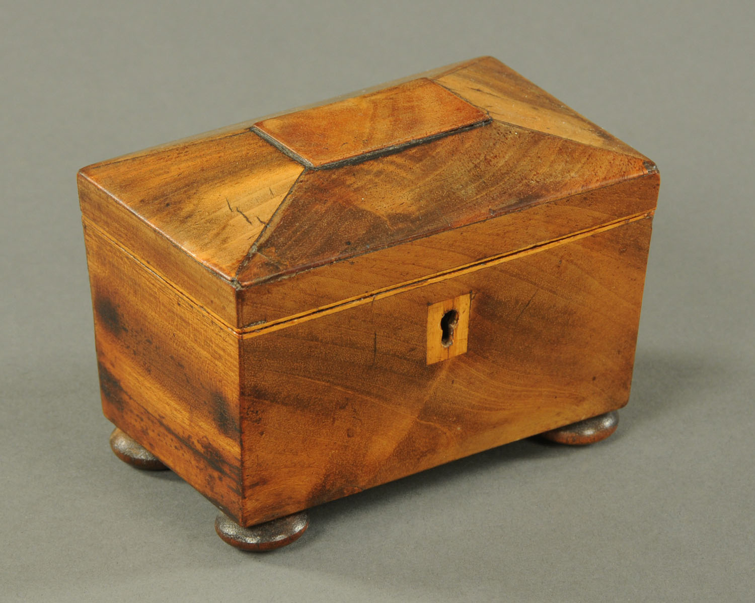 A mahogany miniature tea caddy, mid 19th century, with boxwood stringing and escutcheon,