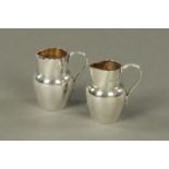 A pair of small cream jugs, Birmingham 1901, maker "JW", 42 grams. Height 51 mm.