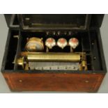 A 19th century Swiss musical box, with walnut and ebonised case, three bells and one drum in sight,