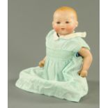 An Armand Marseille bisque headed doll, with jointed composition body.