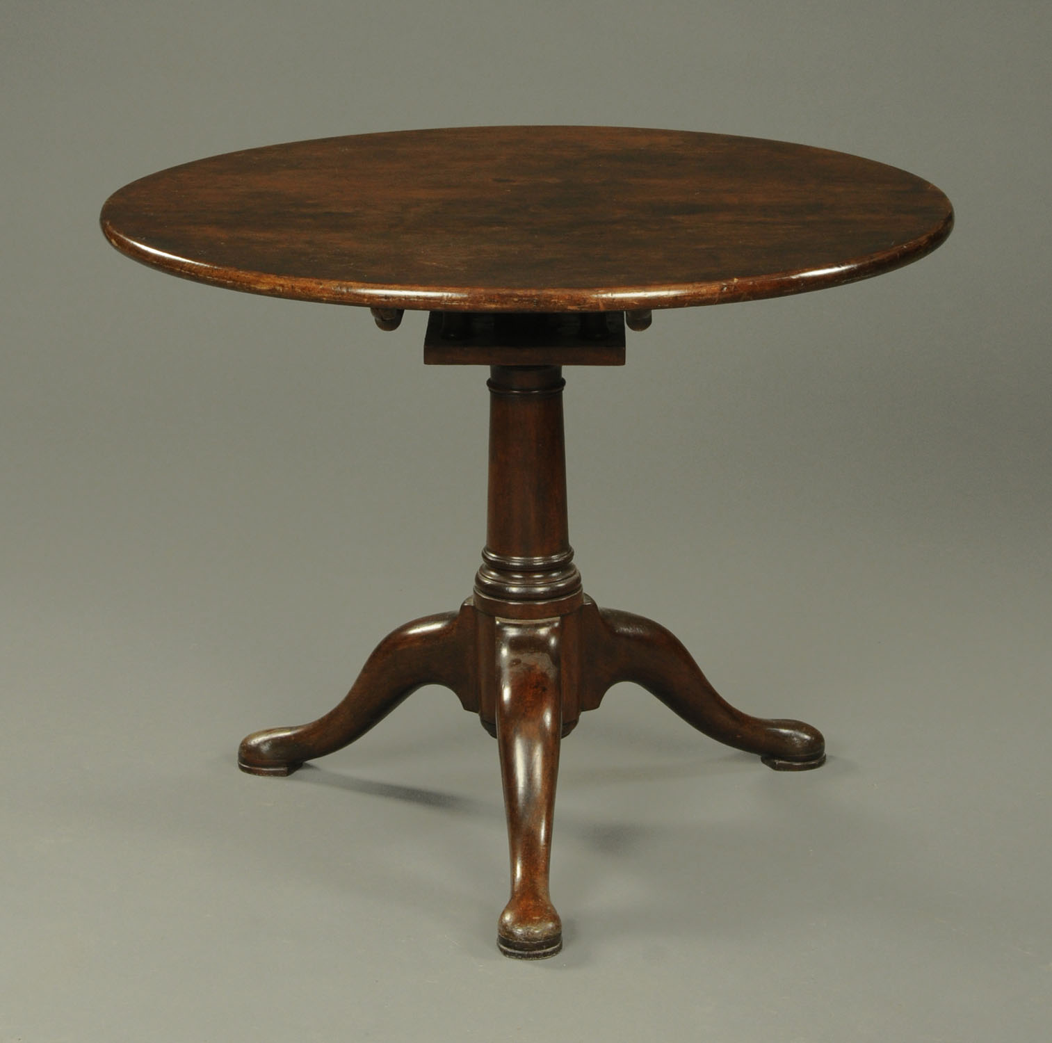 A Georgian mahogany tripod table, with circular top, snap action,