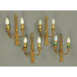 Four gilt brass twin branch wall light fittings. Height 32 cm.