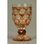 A 19th century Bohemian amber glass and foliate engraved goblet. Height 17 cm.