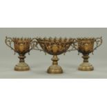 A garniture of three 19th century bronze vases, decorated with cherubs and flaming torches.