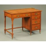 An Edwardian oak desk, with brass gallery, tooled leather writing surface,