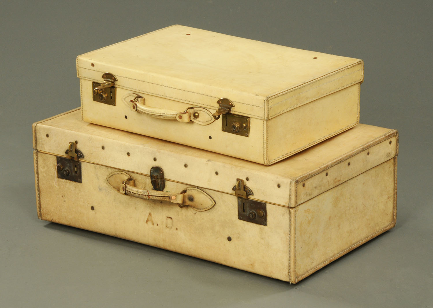 Two vintage pig skin suitcases, the larger with interior lift out tray.