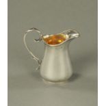 A Victorian silver cream jug, Birmingham 1887, makers mark rubbed, 62 grams. Height 74 mm.