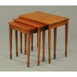 A nest of three mahogany tables, raised on square tapered legs terminating in spade feet.