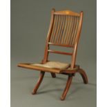 An Edwardian inlaid mahogany folding occasional chair.