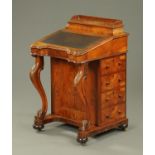 A Victorian walnut Davenport, with rear stationery cabinet, slope front,