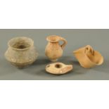 A Roman earthenware oil lamp, with impressed leaf style decoration, small jug,