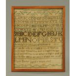 A George III sampler, Mary Beeby 1797, alphabet and text. 9.5 cm x 24 cm, framed.