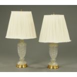 A pair of glass table lamps, with brass fittings and bases, each with pleated shade.