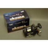 An Okuma Classic XT CLX-300L multiplier with box.