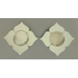 A pair of petal shaped frameless mirrors, early 20th century, having a circular convex centre,