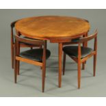 A Danish Frem Rojle teak dining table and four chairs. Table diameter 106 cm.