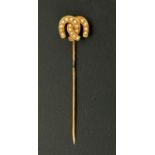 An Edwardian gold coloured seed pearl set double horseshoe stick pin.