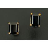 A pair of oblong sapphire stud earrings, set in yellow metal.