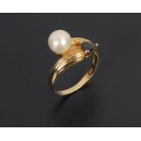 A 1970's design crossover pearl and trillion cut sapphire ring.
