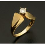 A solitaire diamond ring, in raised setting, with shaped shank stamped "14 K", size L/M, 3.