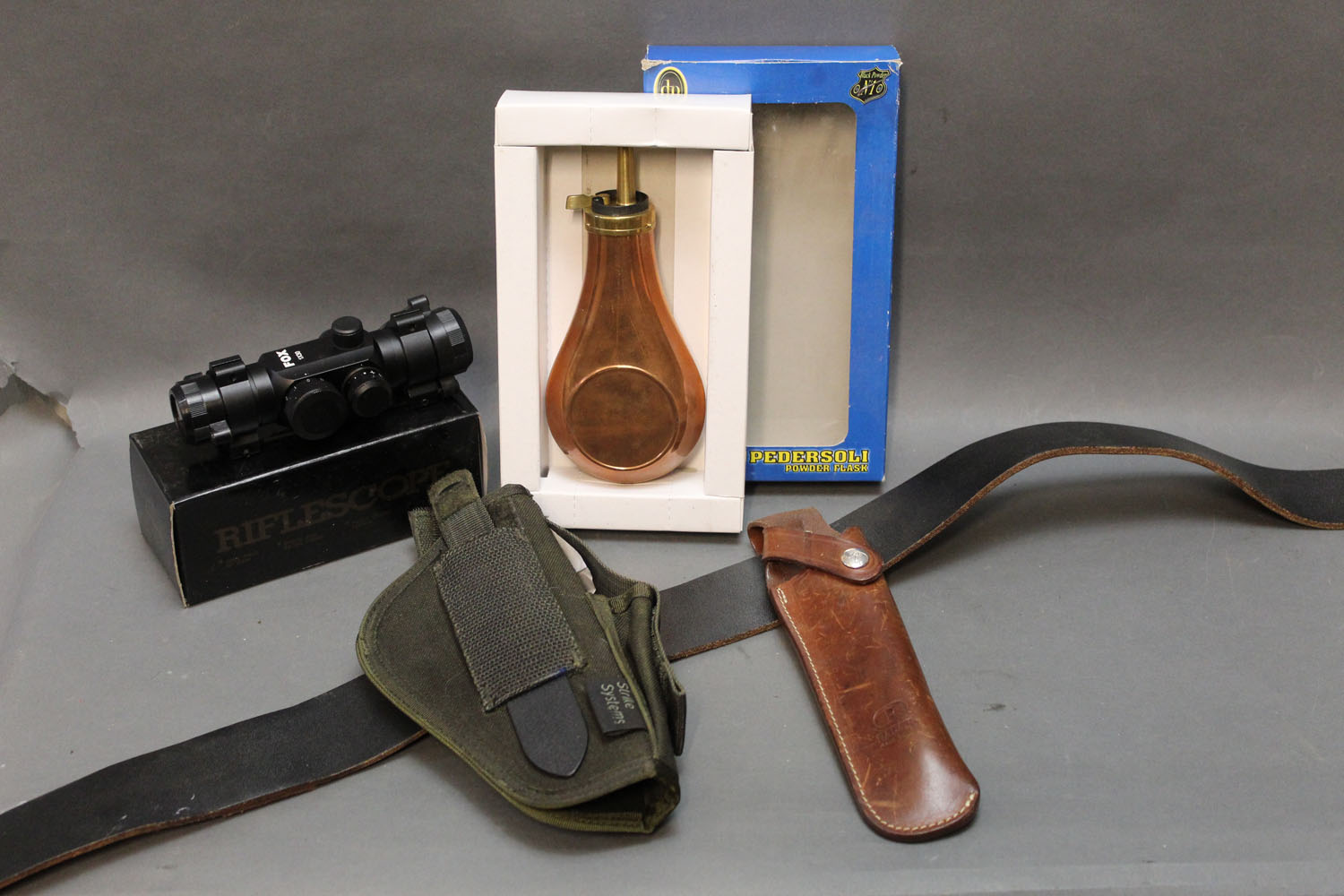 Pedersoli powder flask, fox 1 x 30 rifle scope, Radar bolt holster and pistol holster.