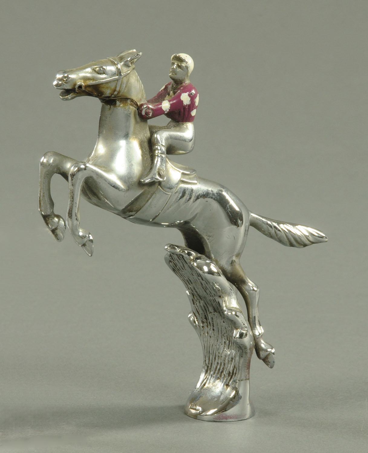 A Desmo chrome plated car mascot, 20th century, modelled as a horse and jockey leaping over a bush,