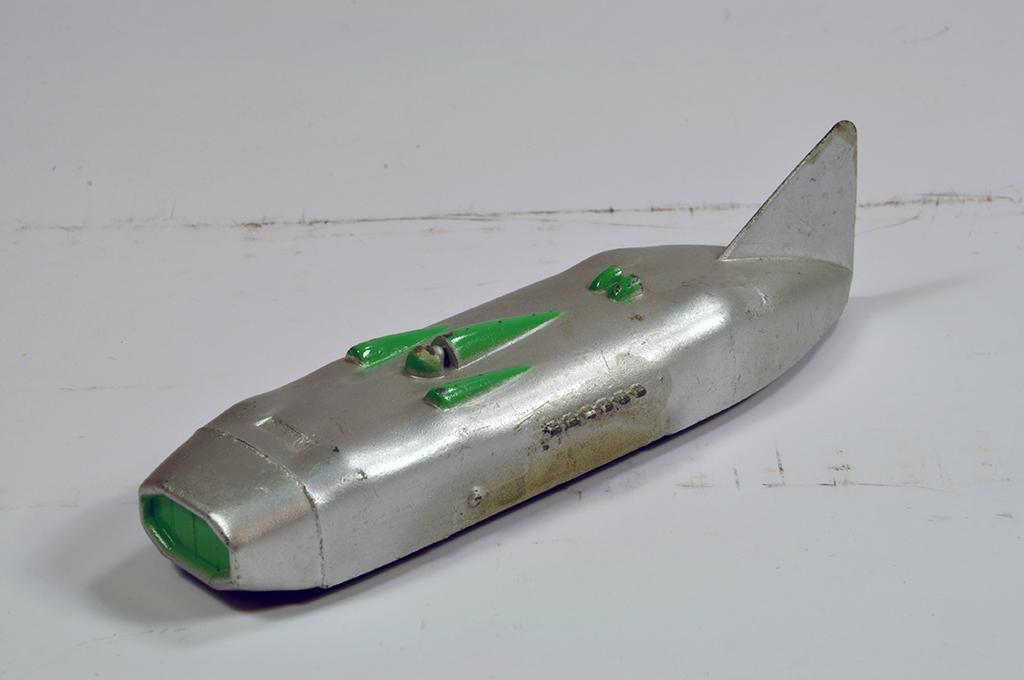 Dinky No. 23s Streamlined (Thunderbolt) Racing Car in silver with green flashes. Generally VG to E.