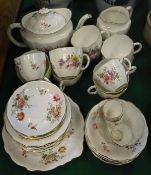 A collection of Royal Crown Derby tea wares decorated with floral sprays on a white ground,