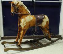A modern dapple-upholstered rocking horse on sleigh type base