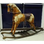 A modern dapple-upholstered rocking horse on sleigh type base