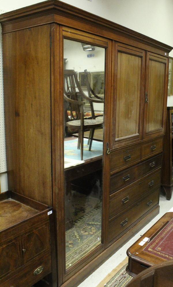 A Victorian walnut wardrobe compactum with two cupboard doors enclosing four linen shelves,