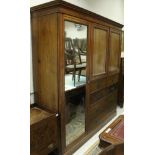 A Victorian walnut wardrobe compactum with two cupboard doors enclosing four linen shelves,