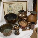 A collection of copper ware to include a beaten copper water vessel,