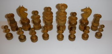 A pine box containing turned boxwood and ebonised chess set