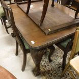 An early 20th Century mahogany rectangular dining table on carved cabriole legs to claw and ball