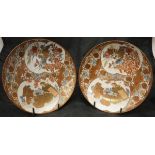 A pair of Japanese Meiji period satsuma ware saucers decorated with panels depicting bird amongst