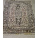 An Eastern cream ground rug with central medallion overlaying three oblong medallions with