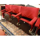 A set of three gold painted cast iron framed folding theatre seats with upholstered back,
